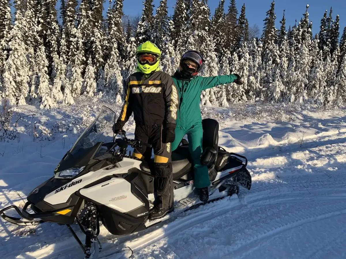 Guided snowmobile ride through snowy trails